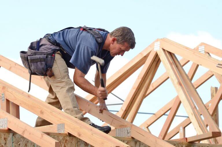 A construction worker working on a roof