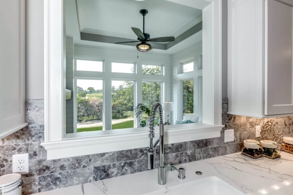 A Lakeview Orono home’s farmhouse sink with a view of the backyard