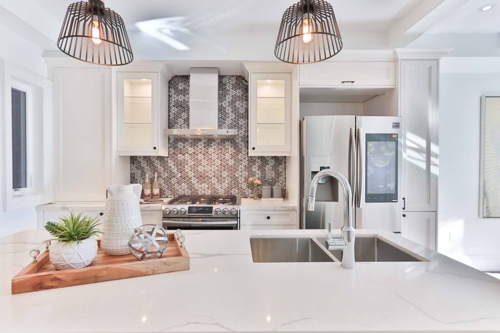 A large kitchen with white granite countertops.