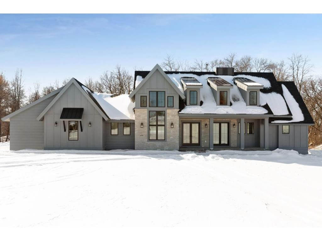The Executive Rambler model home covered in snow